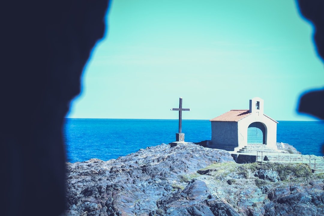Collioure church with striped bell tower by harbor