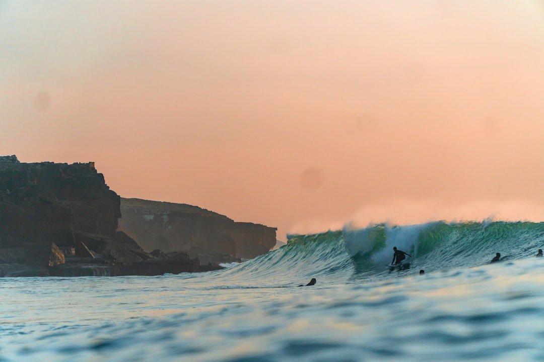 Surfers near rocky reef breaks
