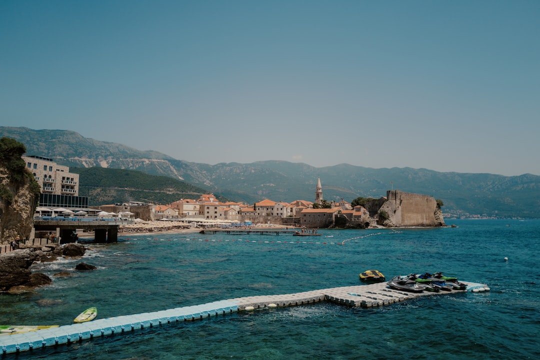 Mogren Beach pebble coves with dramatic cliffs near Budva