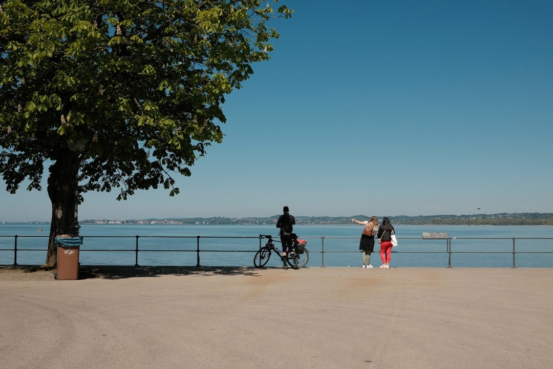 Lakeside town with lighthouse and harbor walkway