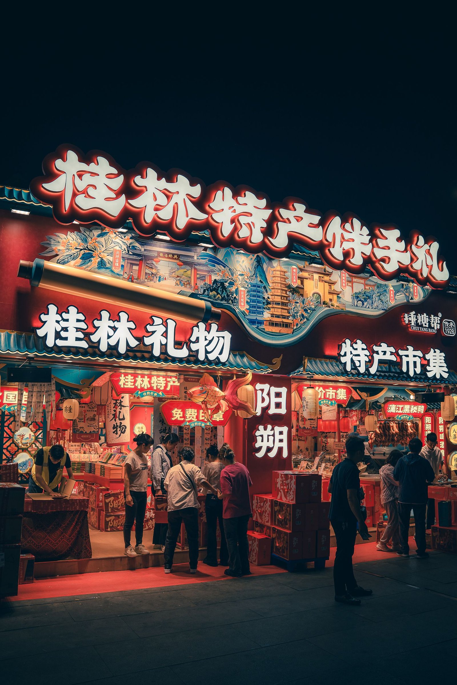 Colorful night market scene in Guilin, China showcasing traditional shops and signs.