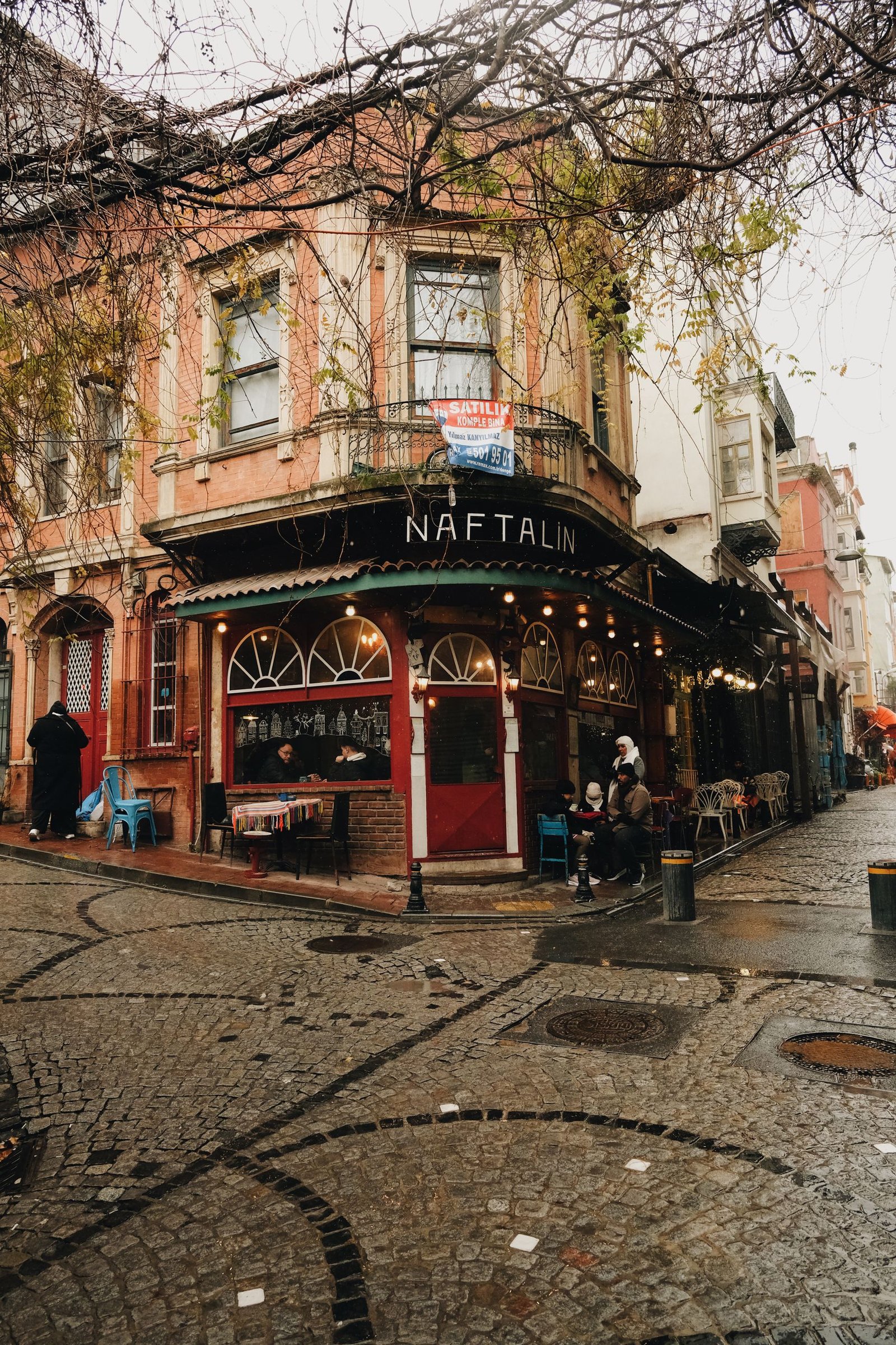 Cozy Istanbul street with Naftalin café on a rainy autumn day.