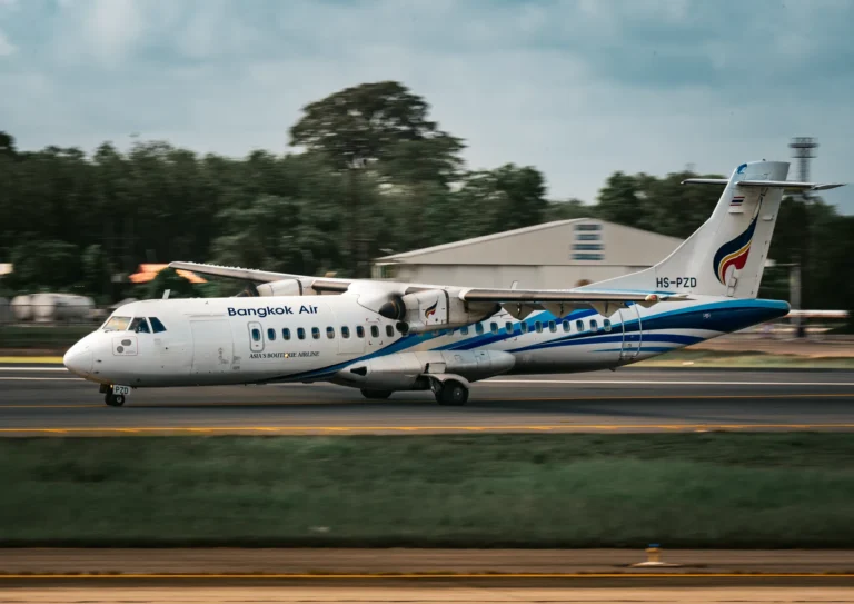 Bangkok Air aircraft accelerating on runway, showcasing aviation speed.