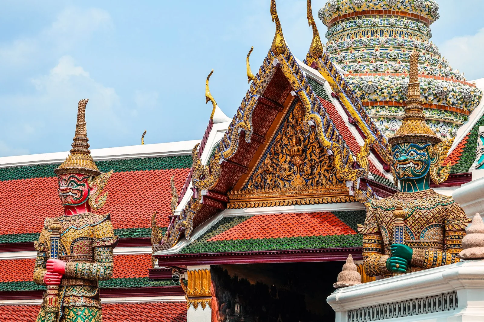 Vivid statues of guardian figures at Wat Phra Kaew, Grand Palace, Bangkok.
