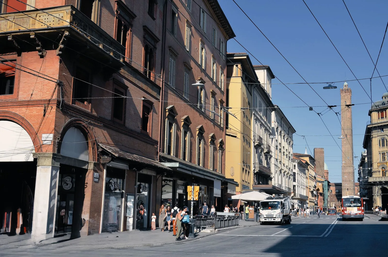 Vibrant city street in Bologna, Italy, capturing daily life and historic architecture.