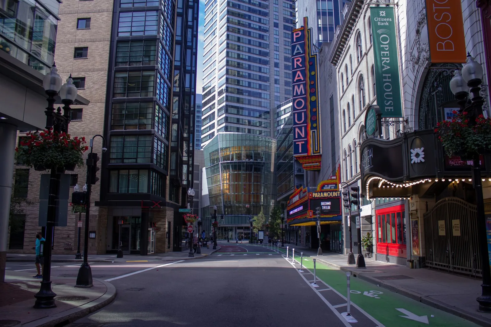 A quiet street in downtown Boston showcasing iconic Paramount marquee and urban architecture.
