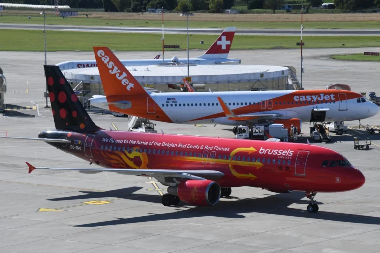 Brussels Airlines plane with Belgian Red Devils livery at Geneva Airport. An easyJet airplane is visible in the background.