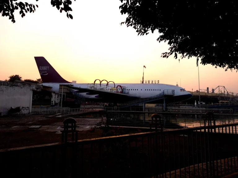 Aerial-themed exhibit with airplane at sunset in Delhi, India. Ideal for travel-themed presentations.