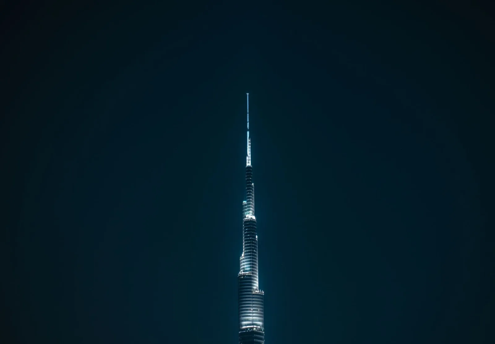 Night view of the illuminated Burj Khalifa in Dubai, showcasing its modern architecture.
