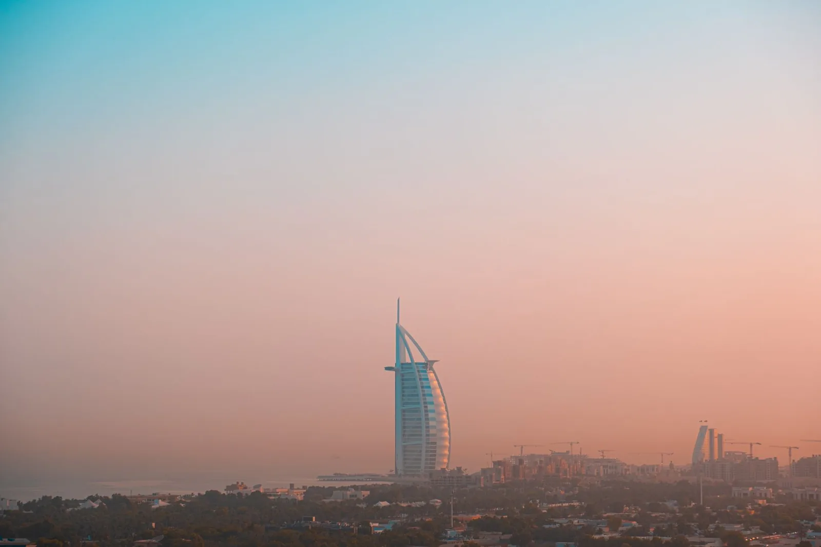 A breathtaking view of the Burj Al Arab with a vibrant evening sky in Dubai.