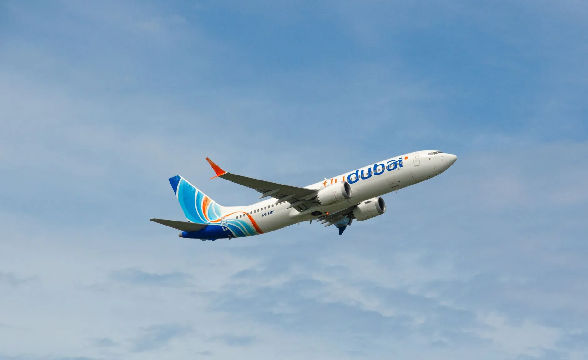 A Flydubai airplane taking off against a blue sky, showcasing modern aviation.