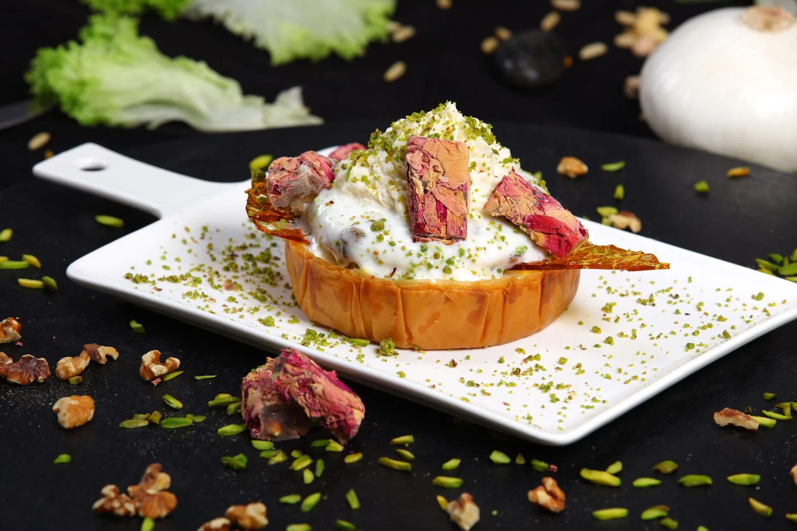 Delicious Middle Eastern dessert with yogurt, rose petals, and nuts on a white plate. Perfect for gourmet food photography.
