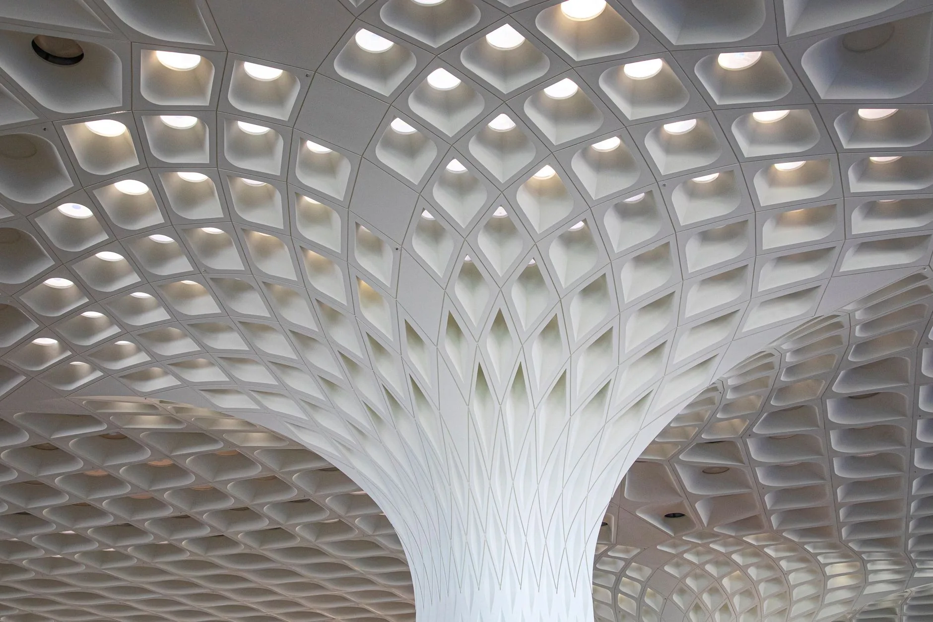 Intricate modern ceiling design at Mumbai Airport showcasing architectural excellence.