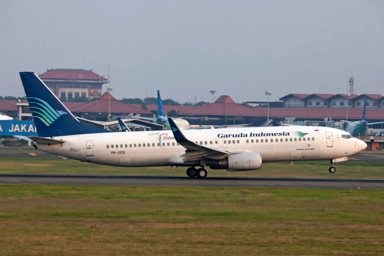 Garuda Indonesia Boeing 737-800 airplane on runway at Jakarta airport.