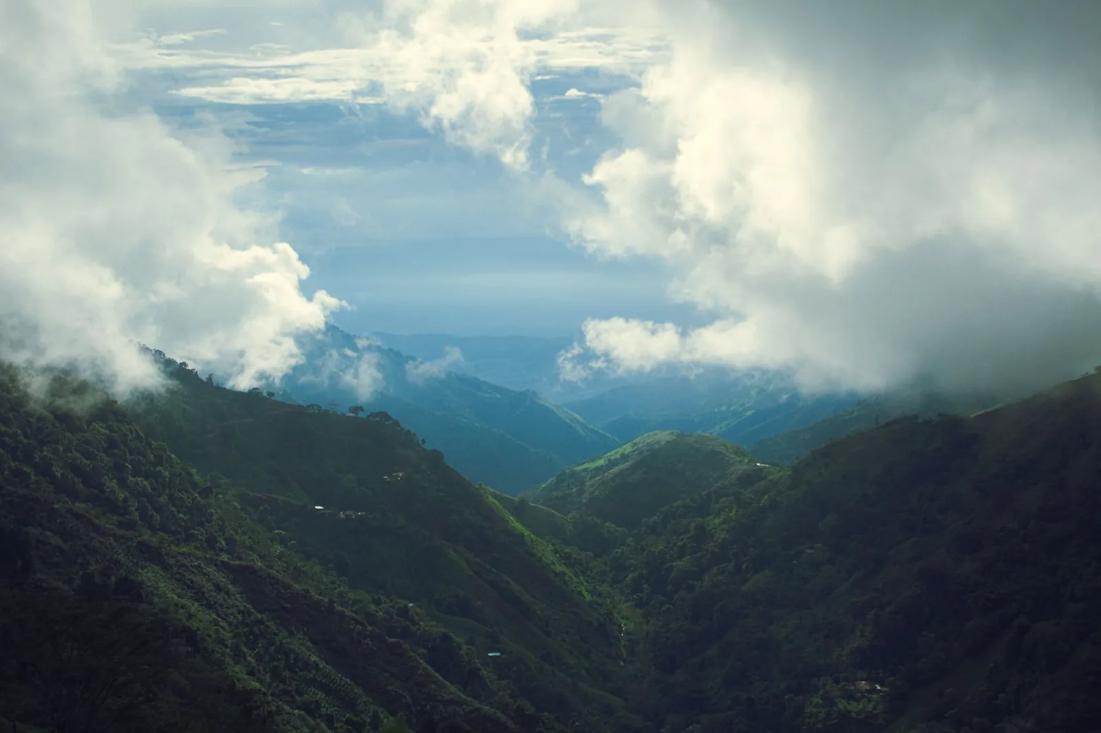 Breathtaking view of lush green mountains surrounded by clouds in Codazzi, Cesar, Colombia.