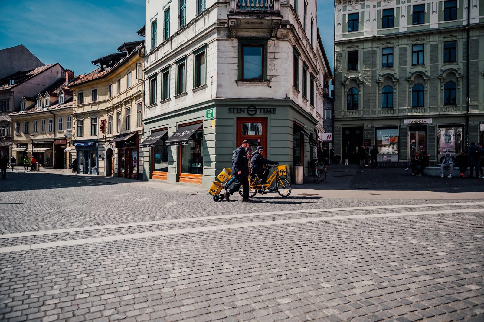 Cobblestone streets and historic architecture in Ljubljana, Slovenia, captured on a sunny day.