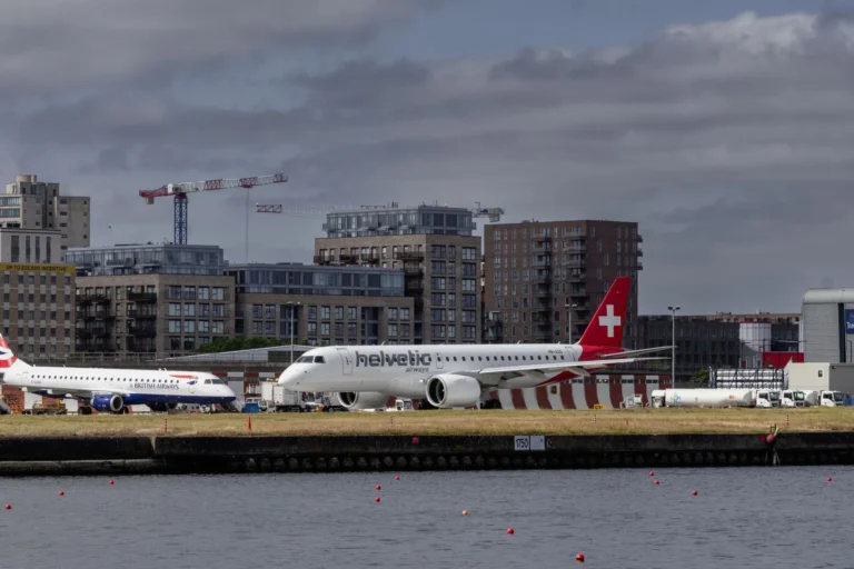 View of British Airways and Helvetic Airways planes at London City Airport.