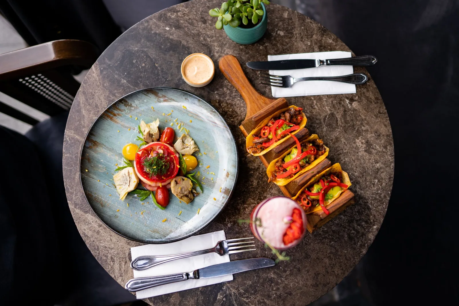 A vibrant top view of tacos and salad on a restaurant table, perfect for food photography.