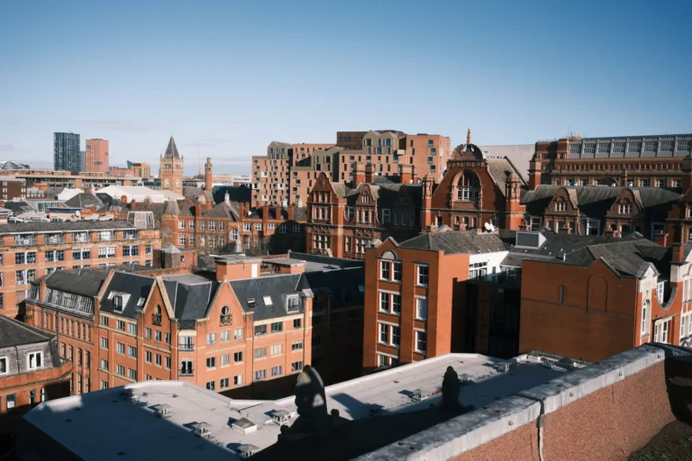 Aerial photo capturing Manchester's historic cityscape with classic red brick buildings.