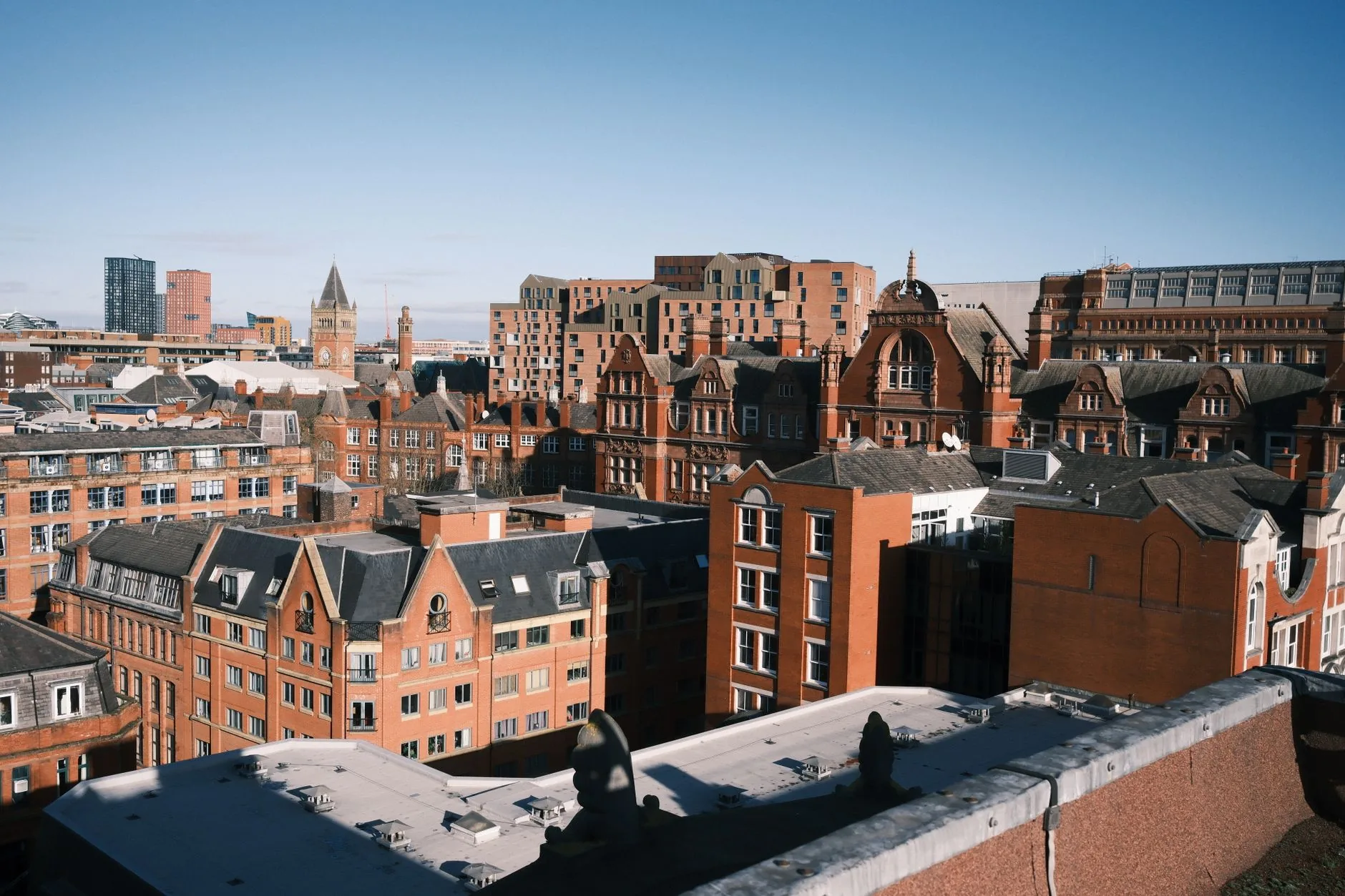 Aerial photo capturing Manchester's historic cityscape with classic red brick buildings.