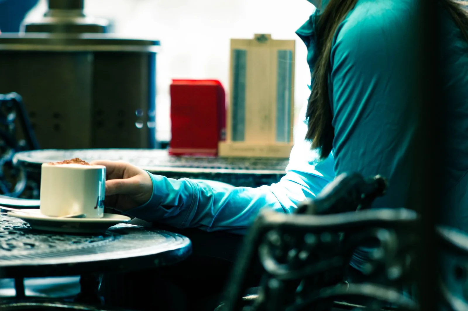 A person enjoying a warm latte in a relaxed coffee shop ambiance.