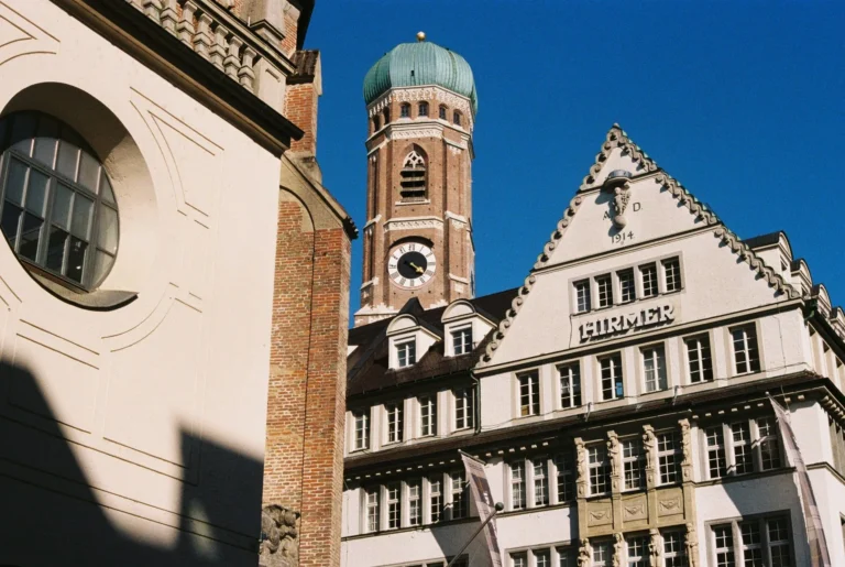 Munich's city architecture featuring a historic church tower and building facade.