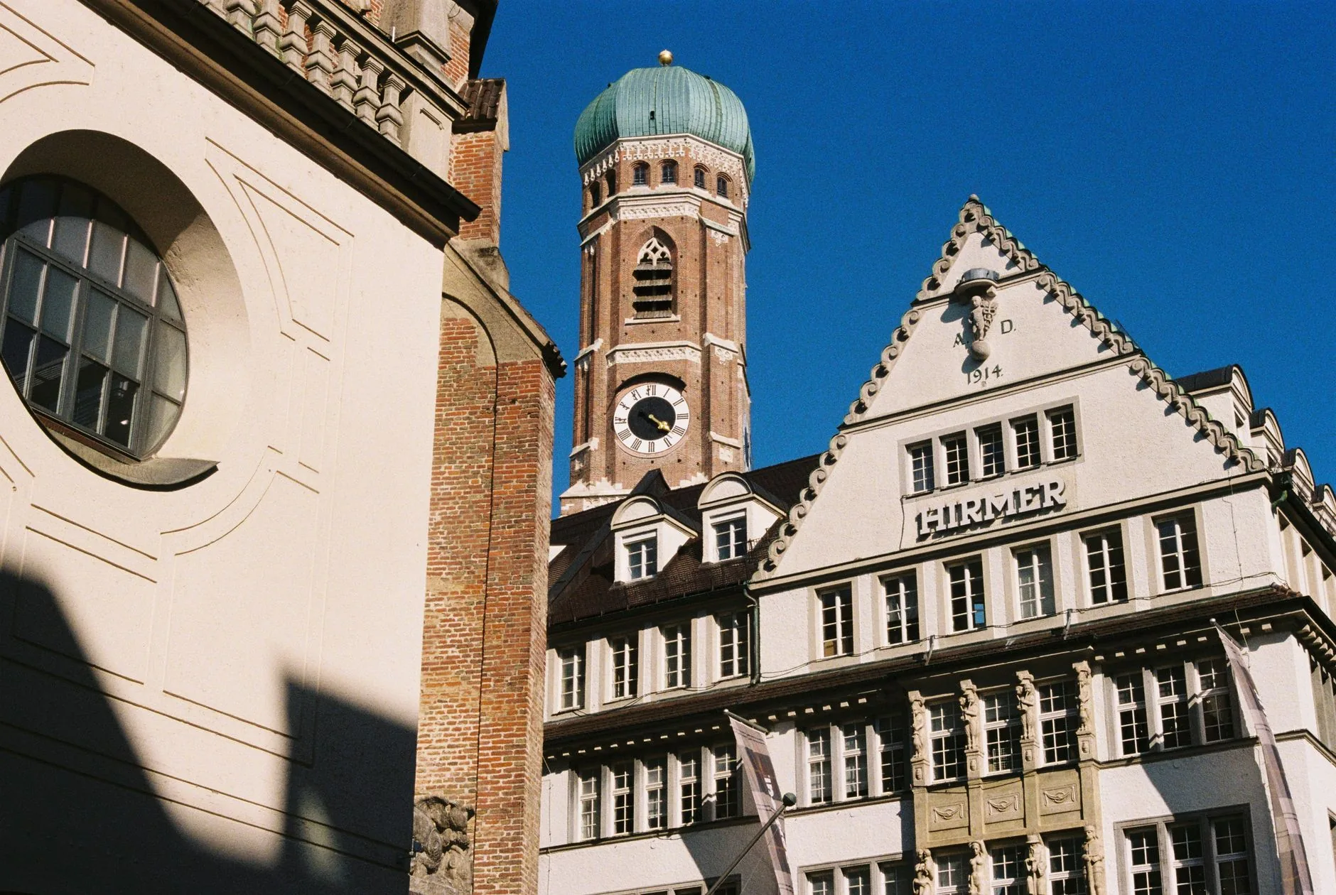 Munich's city architecture featuring a historic church tower and building facade.