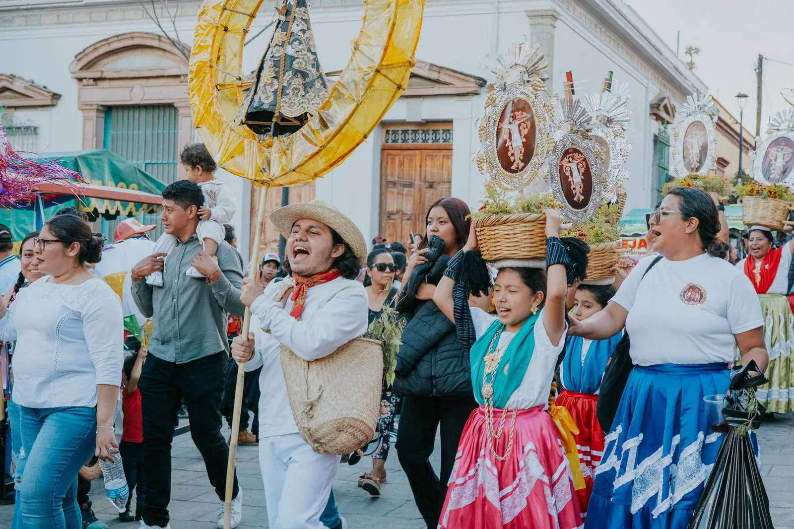 Vibrant street parade in Oaxaca, Mexico featuring festive costumes and cultural rituals.