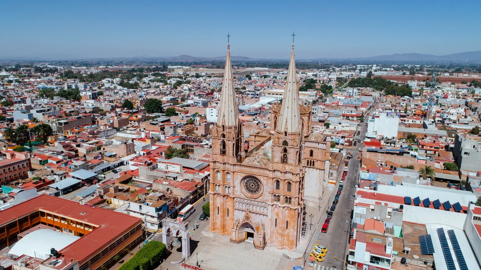 Aerial shot of a Gothic cathedral in urban Mexico, showcasing stunning architecture and cityscape.