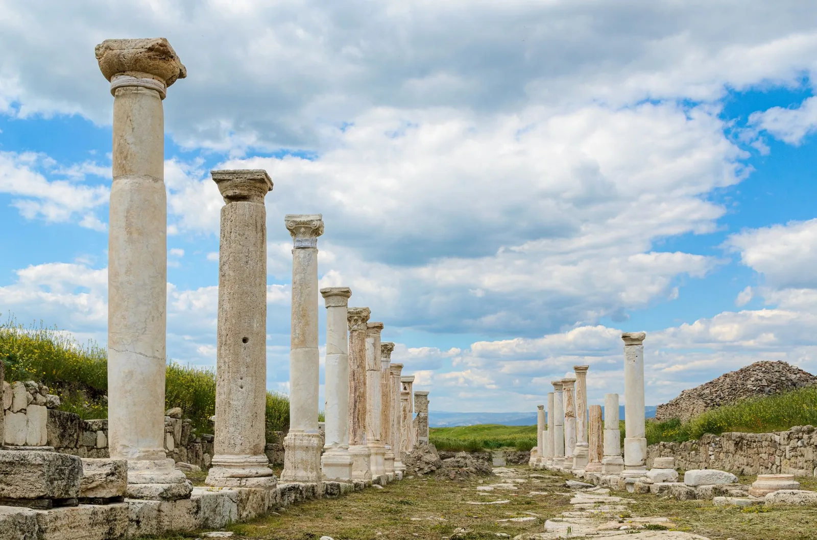 Explore the ancient Roman ruins of Laodikeia with its iconic columns standing against blue skies.