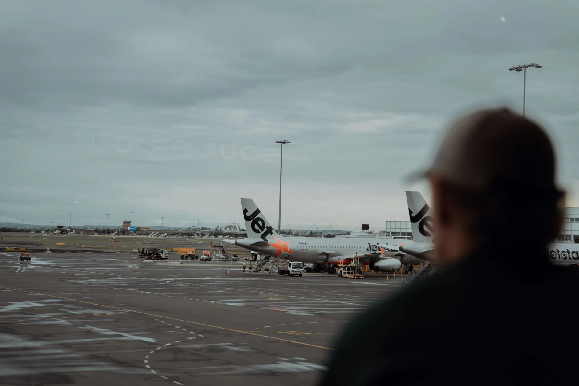 Airplanes at a Sydney airport terminal, illustrating air travel and future airport connections.