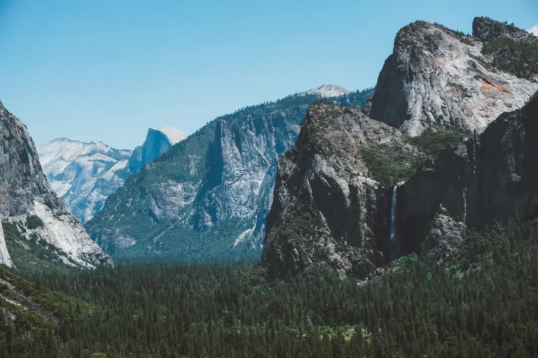 Breathtaking view of Yosemite Valley with a waterfall and granite cliffs in California.