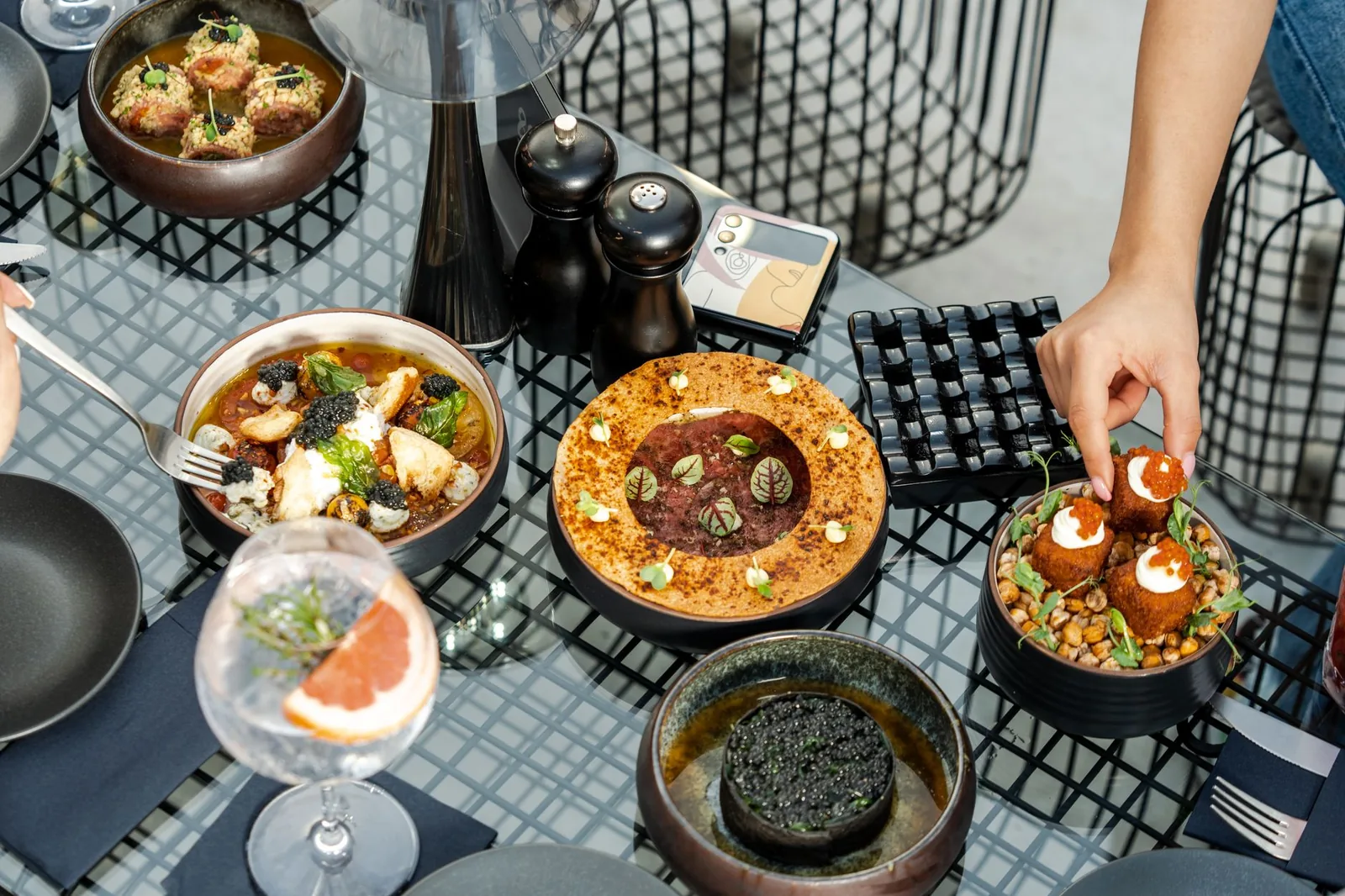 A variety of exquisite gourmet dishes on an outdoor table in Dubai, showcasing Middle Eastern cuisine.