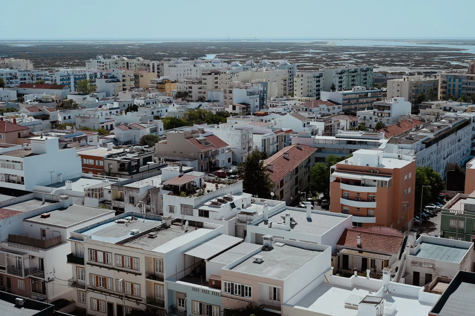 Aerial cityscape of Faro, Portugal showcasing vibrant architecture and urban planning from above.