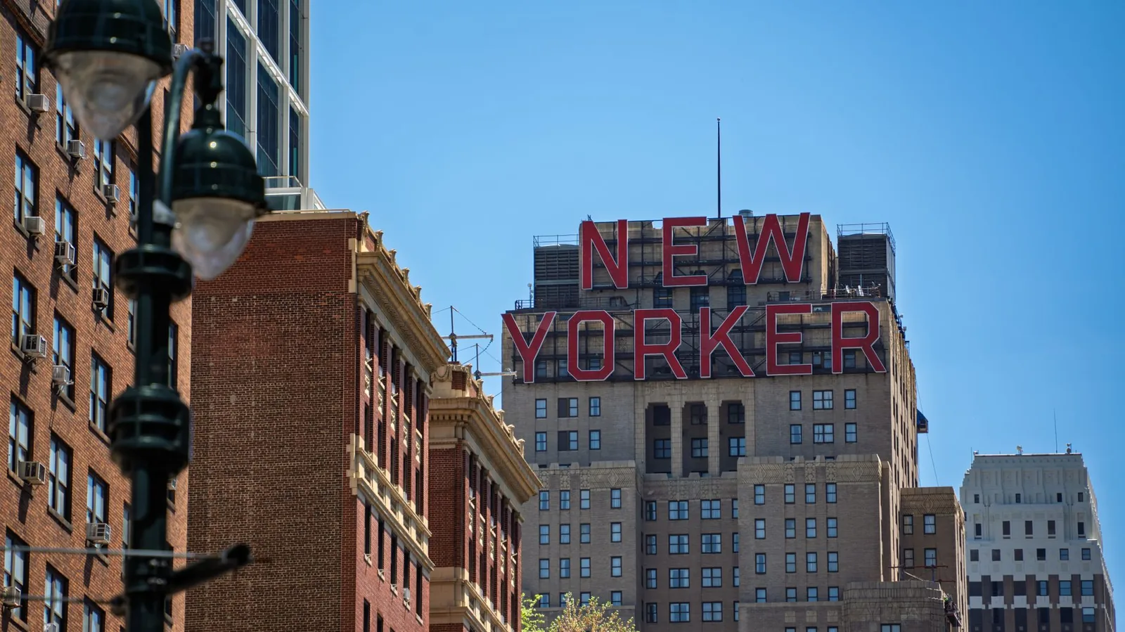 View of the New Yorker building in Manhattan against a clear blue sky.