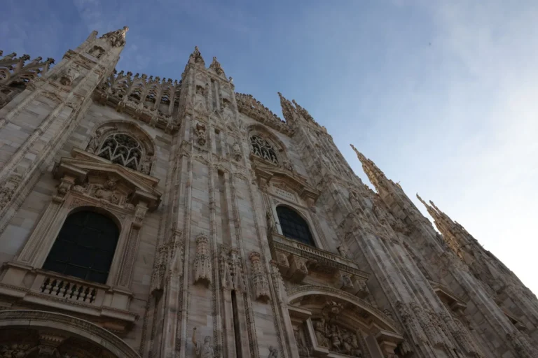 Striking view of Milan Cathedral's Gothic architecture under a clear sky.