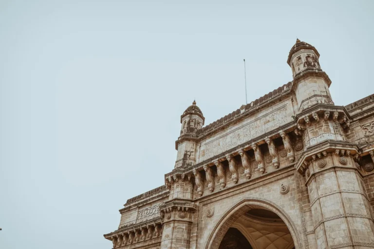 Low-angle view of the Gateway of India showcasing intricate architectural design in Mumbai.