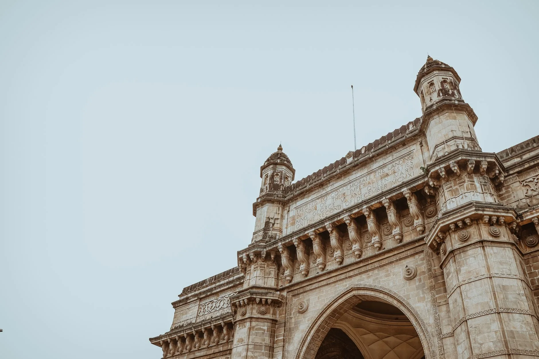 Low-angle view of the Gateway of India showcasing intricate architectural design in Mumbai.