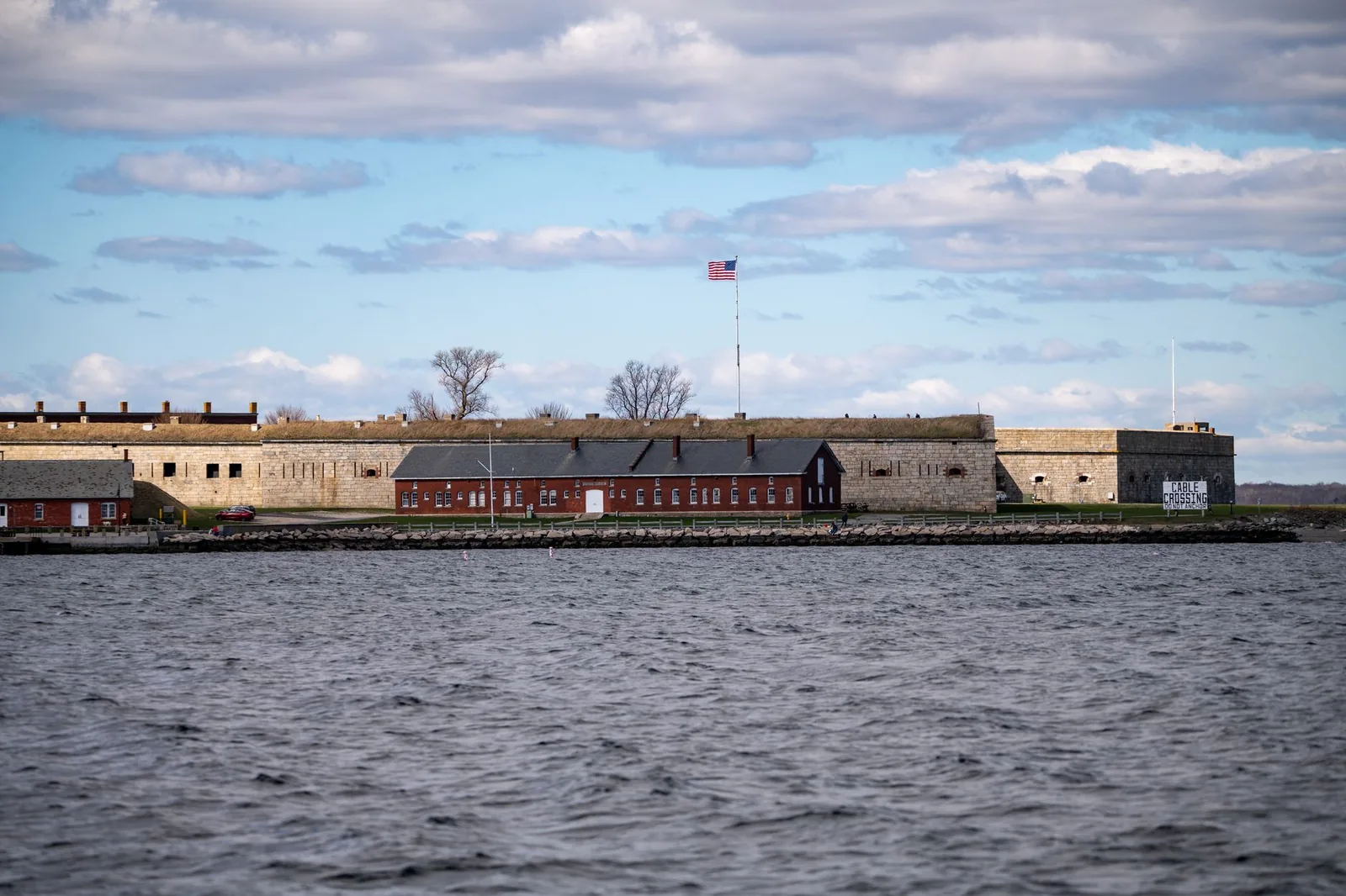View of Fort Adams State Park across the water in Newport, Rhode Island. Sunny day with blue sky.