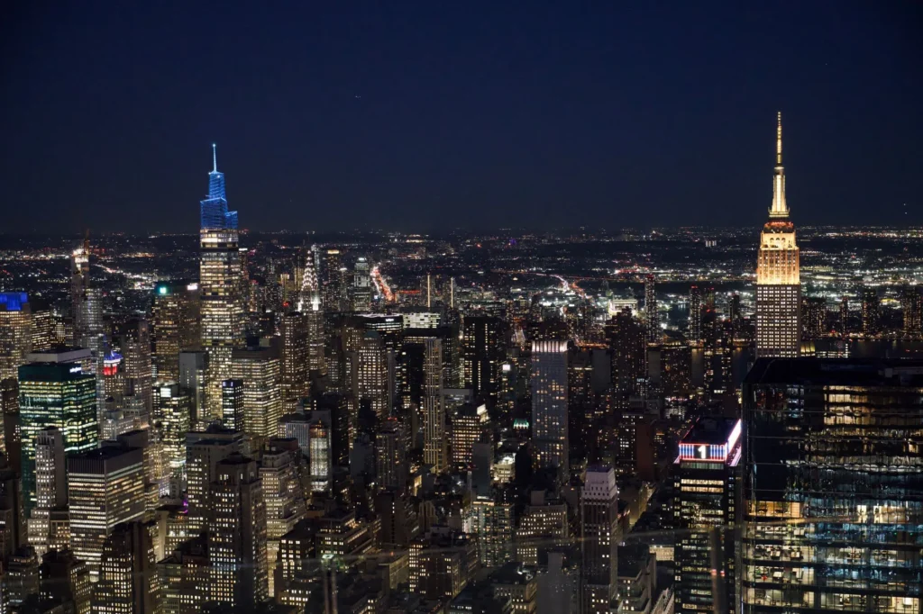 Breathtaking aerial view of New York City skyline at night featuring iconic skyscrapers.