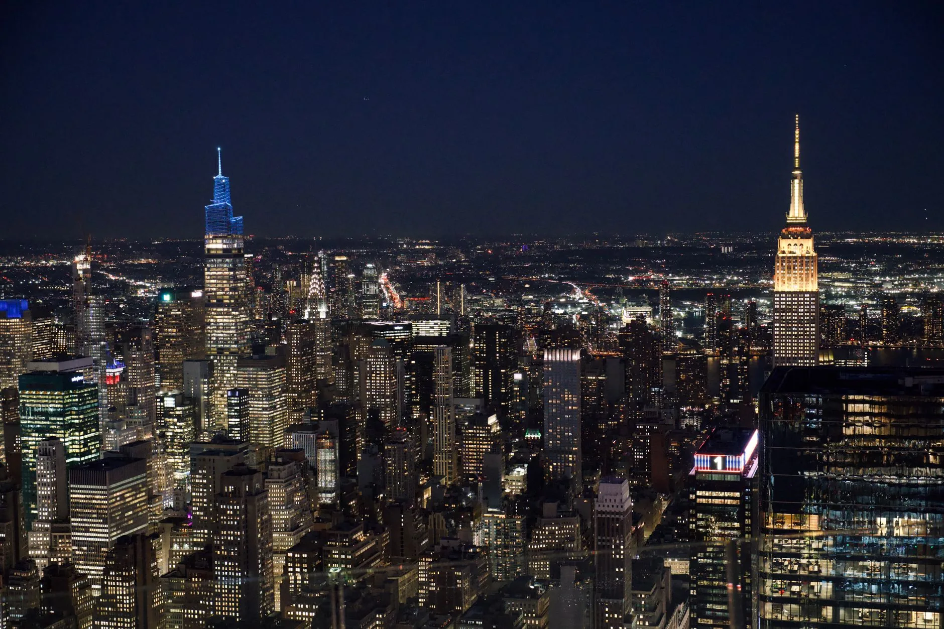 Breathtaking aerial view of New York City skyline at night featuring iconic skyscrapers.