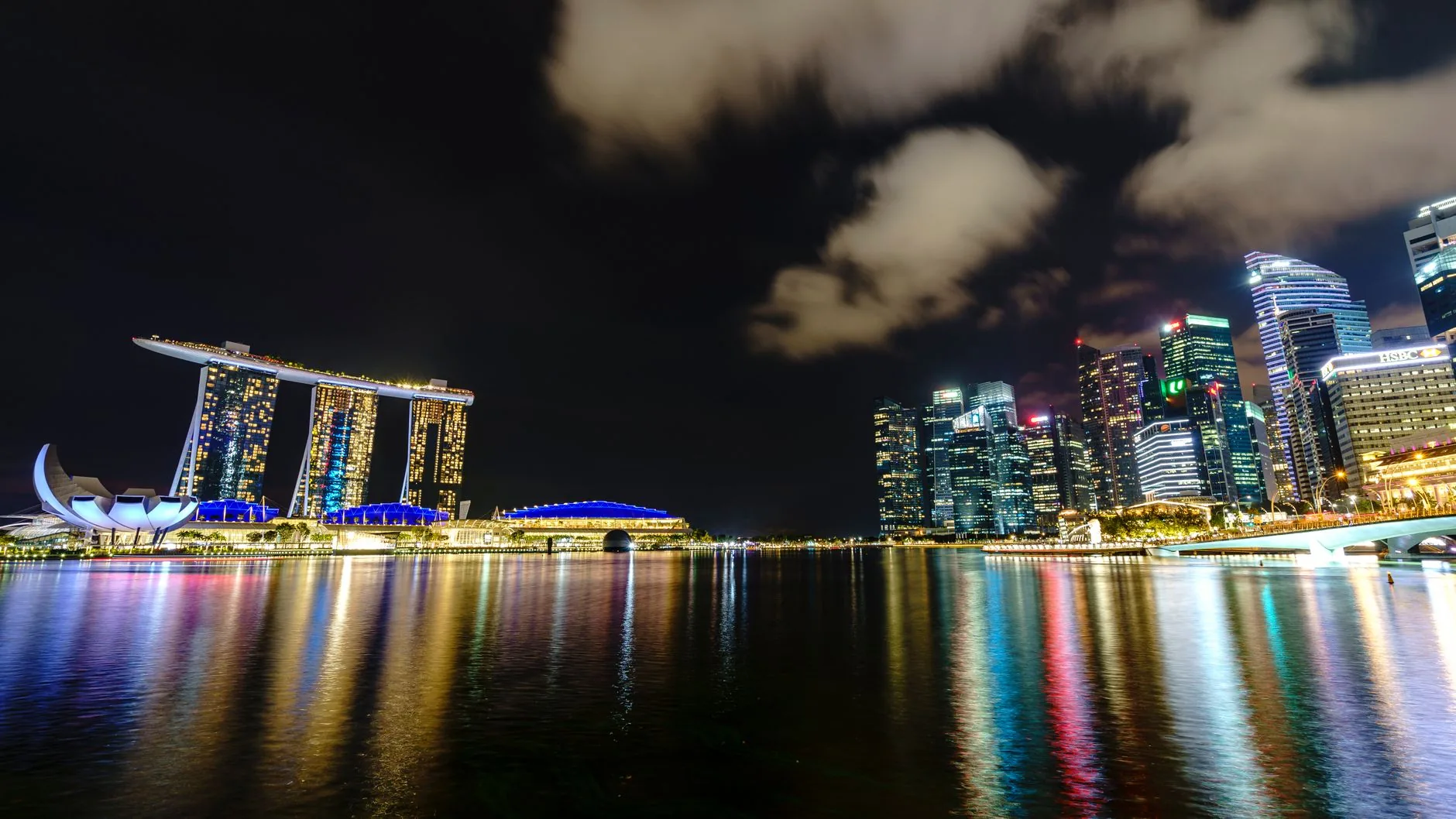 Stunning night view of Singapore's skyline with the iconic Marina Bay Sands and city reflections.