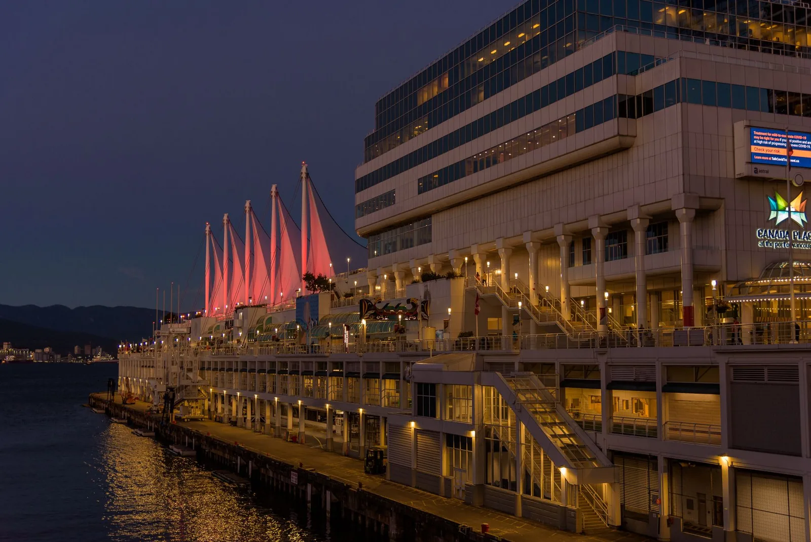 Canada Place in Vancouver beautifully lit during twilight, showcasing modern architecture.